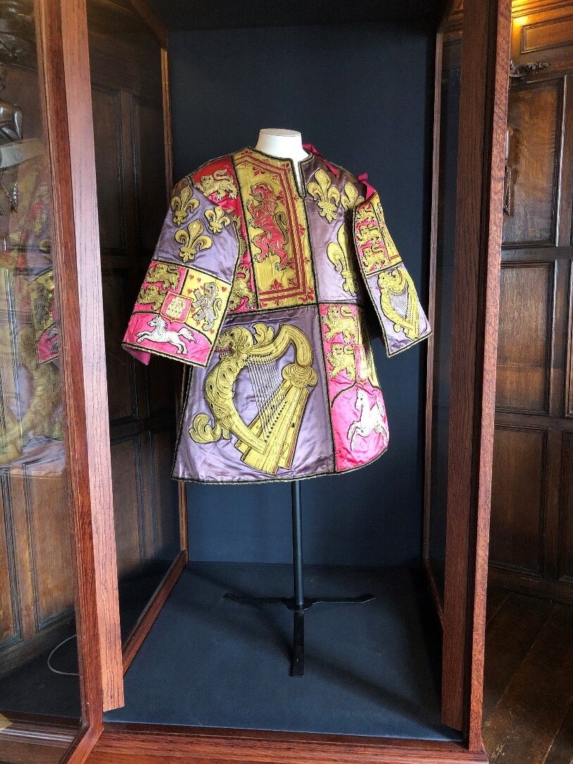 The tabard in the display case.