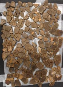Laying out the pottery sherds before reconstruction.